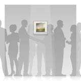Silhouettes of people looking at a framed Harry Brioche picture on a wall.