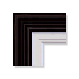 One of our hand crafted picture frames: a piano black, ridged exterior with a matte white, natural woodgrain inner slip.