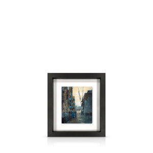 A framed 13 inch artwork featuring the warehouses of Butlers Wharf leading to the River Thames, float-mounted on a black frame.