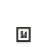 A framed 9 inch artwork featuring the warehouses of Butlers Wharf leading to the River Thames, float-mounted on a black frame.