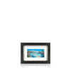 A framed artwork depicting a view from Waterloo Bridge, with a black frame.