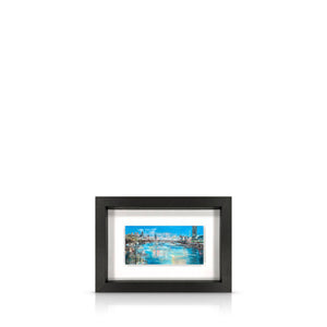 A framed artwork depicting a view from Waterloo Bridge, with a black frame.