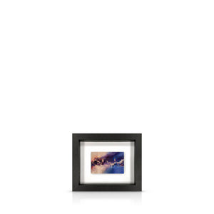 A framed artwork depicting a swirling, expressionistic Houses of Parliament, mounted on a black frame.