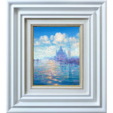 A closer view of Andrew's painting. Elegantly framed in a simple white frame, the painting depicts Venice with bright blue skies and clear sparkling waters.