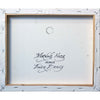 The reverse side of Andrew's painting. Andrew has hand-written the painting title directly  onto the canvas, and stamped his work with his name and qualifications.